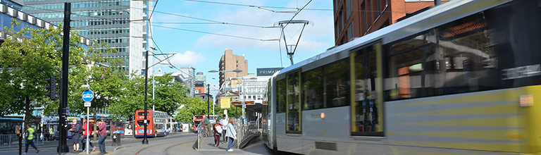 A tram leaving Piccadilly gardens in Manchester city centre