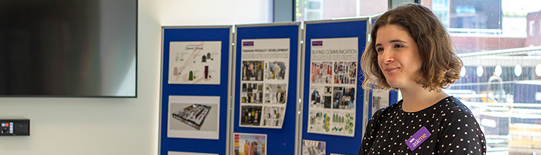Member of staff on a stand at an open day