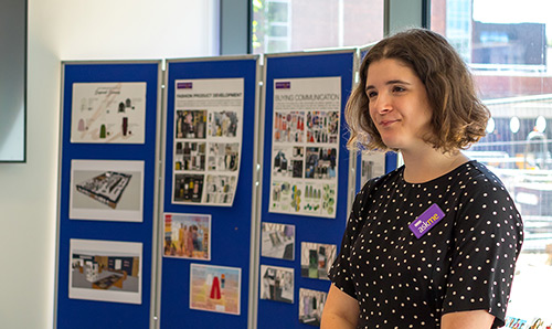 Member of staff on a stand at an open day