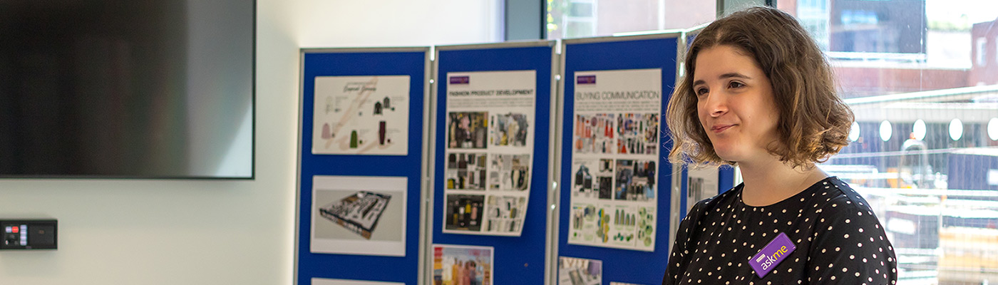 Member of staff on a stand at an open day